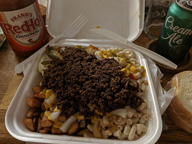 Photo of a cheeseburger plate with macaroni salad, homefries, and everything. Includes bread and butter. Served with a Genesee Cream Ale and Frank's RedHot cayenne pepper sauce.